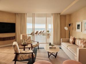 a living room with a couch and chairs at Four Seasons Hotel and Residences Fort Lauderdale in Fort Lauderdale