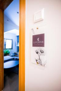 a door with a picture of a dandelion on it at Eumorphia Studios & Apartments in Skiathos Town
