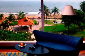 a blue couch sitting on a table with a view of the beach at The Park Visakhapatnam in Visakhapatnam