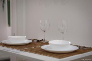 a table with two wine glasses and plates on it at San marco 56 in Bari