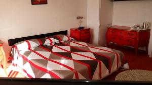 a bedroom with a bed and a red dresser at La Voile D' Or seul hôtel sur le port in Cap d'Agde