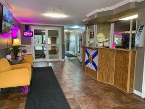 a lobby with a yellow couch and a counter at Harbourview Inn and Suites in Sydney +67 photos
