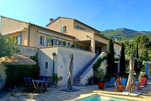 a house with a swimming pool in front of it at Mas Christiane in Buis-les-Baronnies