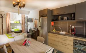 a kitchen with a table and a dining room at 3SSS Bouquet Studios in Marmari