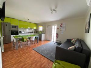 a living room with a couch and a kitchen at Cantinho Verde T2 in Geres