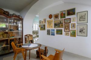 a room with a table and chairs and pictures on the wall at House 1797 - Charm of Slovenian Vintage in Dob