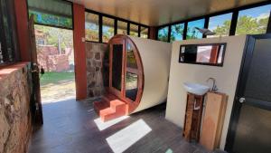 a room with a bathroom with a sink and a mirror at Hotel y Restaurante Las Margaritas in Perquín