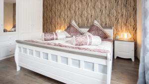 ein weißes Bett mit Kissen darauf im Schlafzimmer in der Unterkunft Feriensuite "Kappe Deluxe" in Winterberg