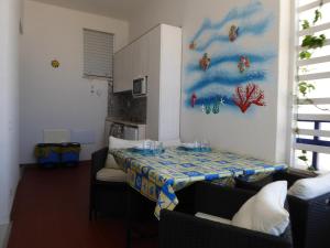 a kitchen with a table with a table cloth on it at Casa Vacanza Anna Maria in Porto Cesareo +7 photos