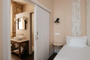 Cama ou camas em um quarto em Casa das Muralhas