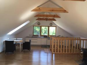 a room with a kitchen and a table in a attic at Domek Nikutowo in Mrągowo