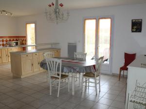 a kitchen with a table and chairs in a room at Maison avec Jardin proche Thermes comprenant Lave-linge et Lave-vaisselle - FR-1-541-47 in La Roche-Posay