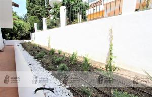 Jardín al aire libre en Pueblo del parque 12 - Terraza - Piscina y Playa- Urbanización tranquila- Perfecto para descansar
