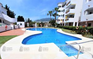 Piscina en o cerca de Pueblo del parque 12 - Terraza - Piscina y Playa- Urbanización tranquila- Perfecto para descansar
