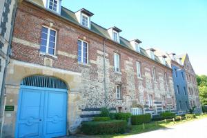 a large brick building with a blue door at Chez Lisette Honfleur 500m plage in Honfleur