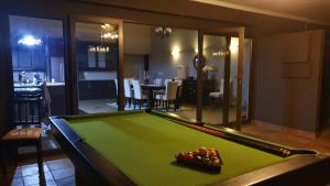 a pool table in a living room with a pool table at 113 Zwartkloof Private Game Reserve Bela-Bela in Bela-Bela