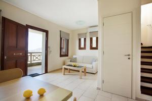 a living room with a couch and a table at Aithra -Agios Petros Andros in Gavrio