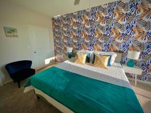 a bedroom with a large bed with a colorful wall at Tropical Breeze - 2BR/NRG/Medical Center/Galleria in Houston +35 photos
