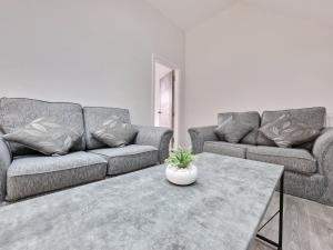 a living room with two couches and a coffee table at DYSA Waterloo Apartments in Blackpool