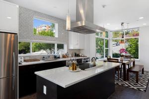 a kitchen with a large island in the middle at Deactivated- Rooftop Patio with Grill 2BR 3BA Central, Walkable Location in Seattle