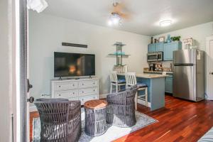 a kitchen with a stainless steel refrigerator and a counter at Parkside Cottage in Jacksonville