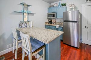 a kitchen with a stainless steel refrigerator and a counter at Parkside Cottage in Jacksonville