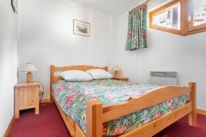 a bedroom with a bed and a window at Bright Cocoon With Balcony And View On The Valley in Courchevel