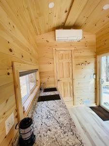 a log cabin with a sink and a window at Trailside Stays in Rumney