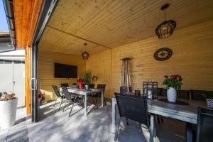 een eetkamer met een tafel, stoelen en een klok bij Willa Arkadia in Pobierowo