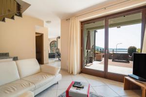 a living room with a couch and a sliding glass door at Casa Marina in Mergozzo
