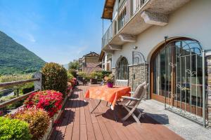 a patio with a table and chairs on a building at Casa Marina in Mergozzo