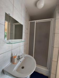 a bathroom with a sink and a shower at Namelis ir marios in Nida