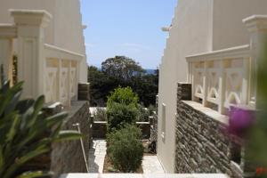 an external view of a house with a stone wall at Aithra -Agios Petros Andros in Gavrio