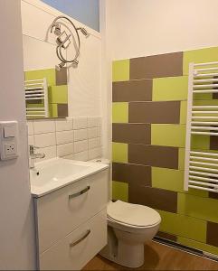 a bathroom with a toilet and a sink at Appartement de charme plein coeur de Moulins in Moulins