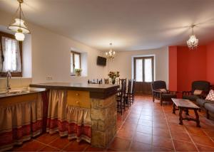 a kitchen with a bar and a living room at Paloma in Ansó