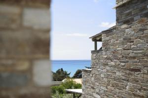 a view of the ocean from a brick building at Aithra -Agios Petros Andros in Gavrio