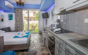 a kitchen with a sink and a bed in a room at 3SSS Bouquet Studios SEA in Marmarion +25 photos
