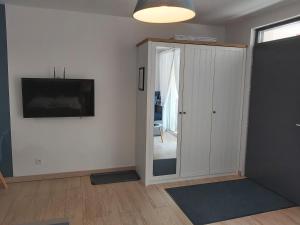 Televízia a/alebo spoločenská miestnosť v ubytovaní Apartament Niebieski z tarasem