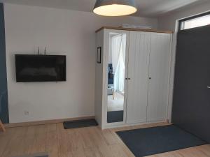 a living room with a sliding door and a television at Apartament Niebieski z tarasem in Szczyrk