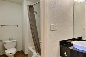 a bathroom with a toilet and a sink at Motel 6-Bismarck, ND in Bismarck +16 photos