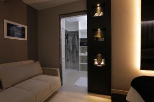 a living room with a couch and a walk in closet at Uchôa Teresina Hotel in Teresina