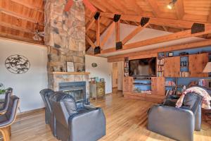 a living room with leather chairs and a fireplace at Family Retreat with Deck Near Appalachian Trail! in Berryville