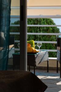 a table with a bowl of fruit and a glass at Apartment in Skala Fourkas in Skála Foúrkas