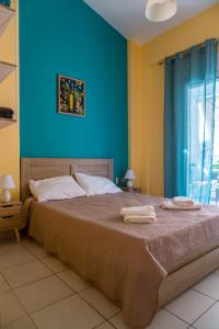 a bedroom with a large bed with two towels on it at Apartment in Skala Fourkas in Skála Foúrkas