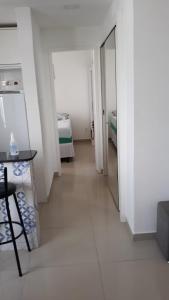 a hallway with a room with a bed and a table at Temporada in Salvador