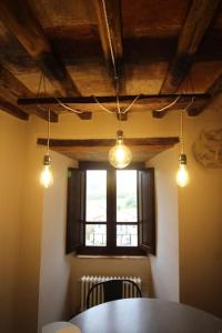 casa vacanze Castiglione - 4 posti letto في Castiglione della Valle: غرفة مع طاولة ونافذة وأضواء