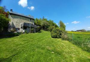 a house in a field with a grass yard at Maison d'Engon charme nature in Beauraing