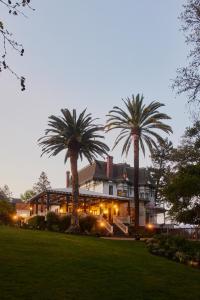 a large house with palm trees in front of it at The Madrona in Healdsburg