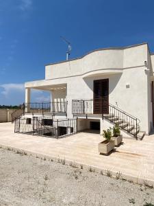 a large white building with a large patio at Casa vacanze Rosemary in Nardò