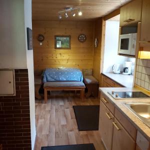 a small kitchen with a bench in a tiny house at Haus Sonnenalm in Forstau